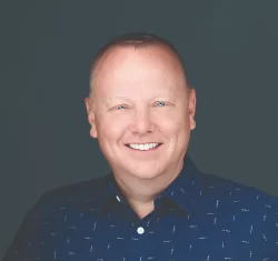 Coby Pewitt wearing a marathon finisher's medal and a "Team in Training" shirt after completing a World Marathon Major.