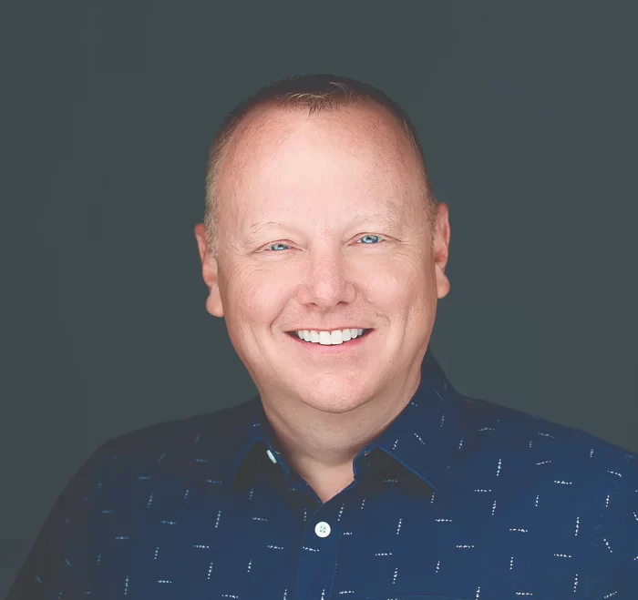 Coby Pewitt wearing a marathon finisher's medal and a "Team in Training" shirt after completing a World Marathon Major.