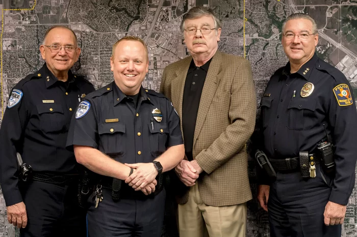 Coby Pewitt in his official Richardson Police Department Assistant Chief uniform, standing in front of the RPD seal.