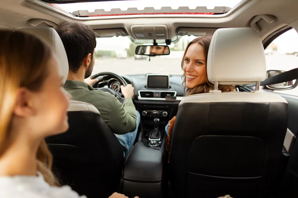 Adult and child seated in a vehicle during a car ride conversation, illustrating an everyday opportunity for family communication.