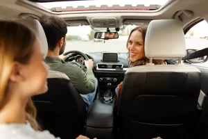 Adult and child seated in a vehicle during a car ride conversation, illustrating an everyday opportunity for family communication.